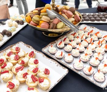 Close up of some desserts at the Presidential Farewell Reception at University at Buffalo's Center for the Arts, including tarts, cookie bites and macarons. Photo by Bellini Studios.