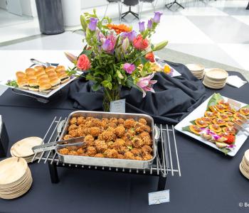 Table of hors d'oeuvres at the Presidential Farewell Reception at University at Buffalo's Center for the Arts, including sliders, arancini, and tostada. Photo by Bellini Studios.