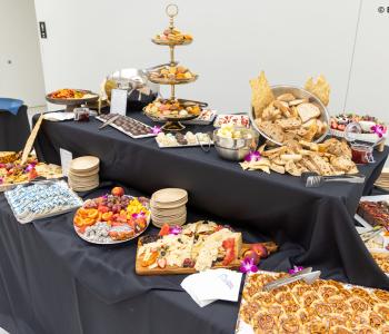 Dessert, bread and cheese displayed on a table at the Presidential Farewell Reception at University at Buffalo's Center for the Arts. Photo by Bellini Studios.